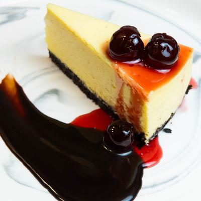 Cheesecake slice with cherry topping.