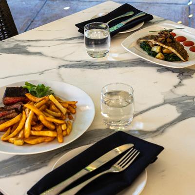 Grilled sirloin steak and fries, and Roasted Black Bass.