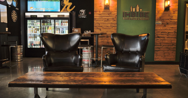 Interior, seating area, lots of drinks in the fridge in the background