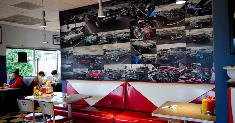 Interior, seating place near wall decorated with car pictures