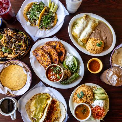 Assortment of dishes served on the table with drinks and condiments.