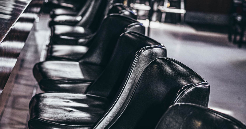 Interior, closeup of lined up chairs at the bar