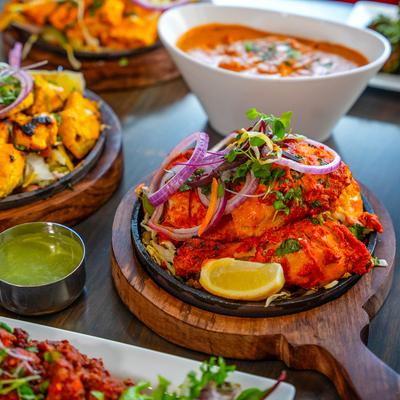 Roasted chicken marinated in yogurt and spices, accompanied with additional dishes.