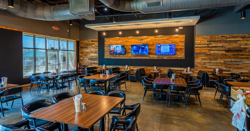 Interior, chairs and tables, 3 TV's on the wall