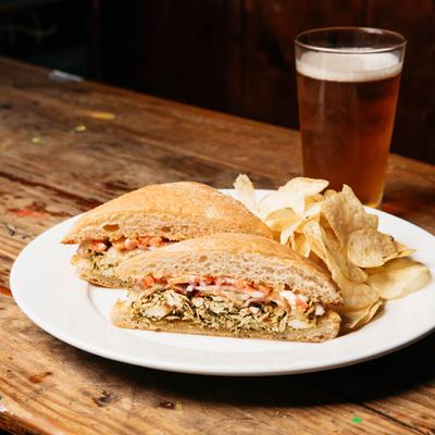 Pesto Chicken Sandwich, chips and a glass of beer