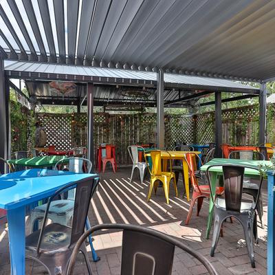 Tables and chairs on the patio outside.
