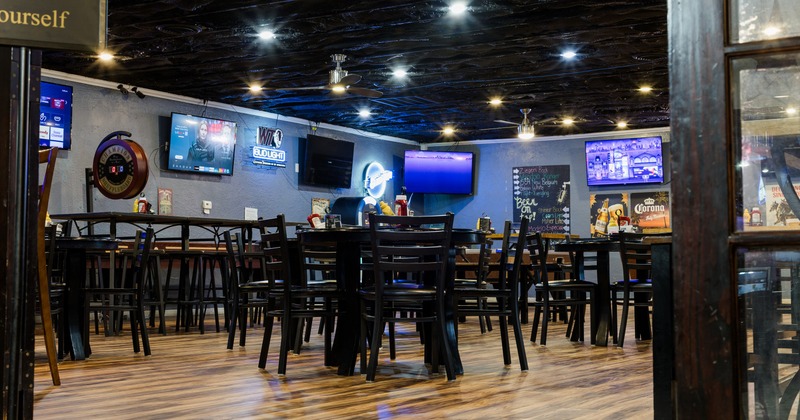 Interior, seating space with TV screens on the walls