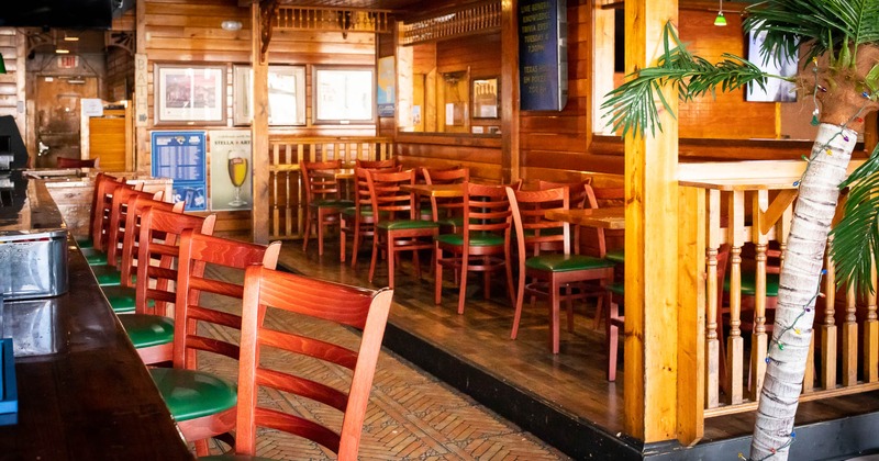 Interior, bar stools on left and tables and chairs on right