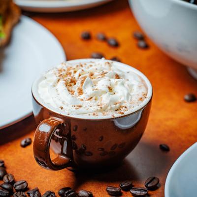 Boffee beverage topped with whipped cream and a sprinkle of cinnamon.