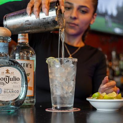 Bartender pouring a cocktail.
