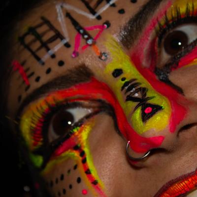 A closeup on a painted face of a person.