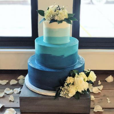 Gradient blue three tier cake with floral decoration