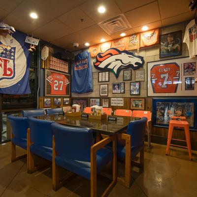 Interior, seating area, NFL jerseys, and motifs on the wall