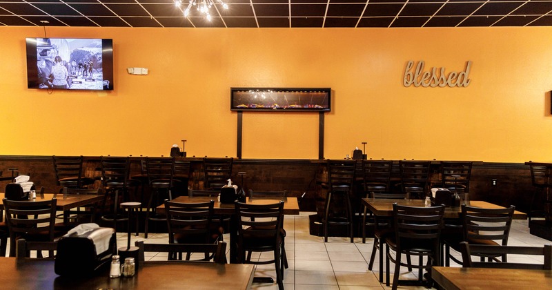 Interior, open space dining area, tables and chairs ready for guests, regular and high seating