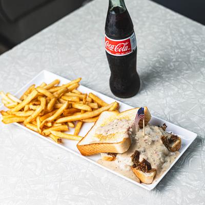The hot pastrami sandwich and a cola bottle.