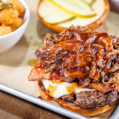 Bacon cheeseburger with pickles, grilled onions, and BBQ sauce.