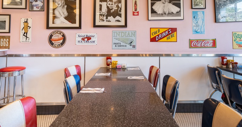 Diner table, chairs, wall with photos and posters