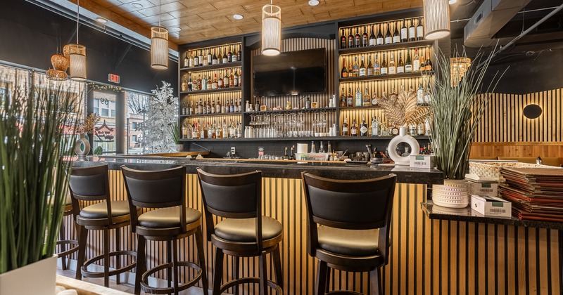 Interior, bar, bar stools, drink rack behind, tv screen