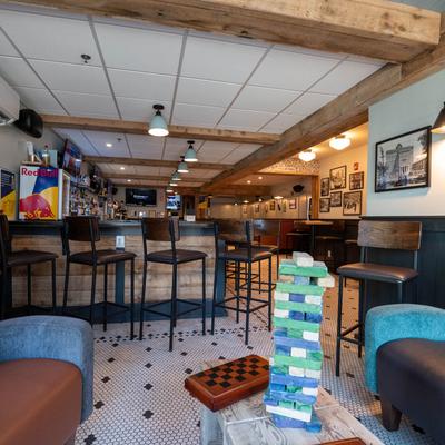 Interior with a  wooden bar, seating  area.