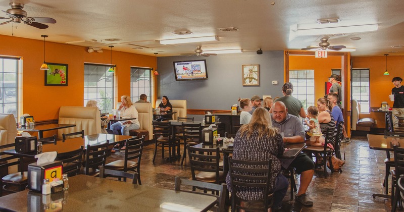 Interior, guests scattered around the dining room, staff taking an order