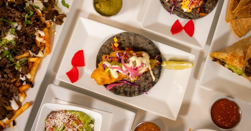 Fish taco served alongside other meals, top view