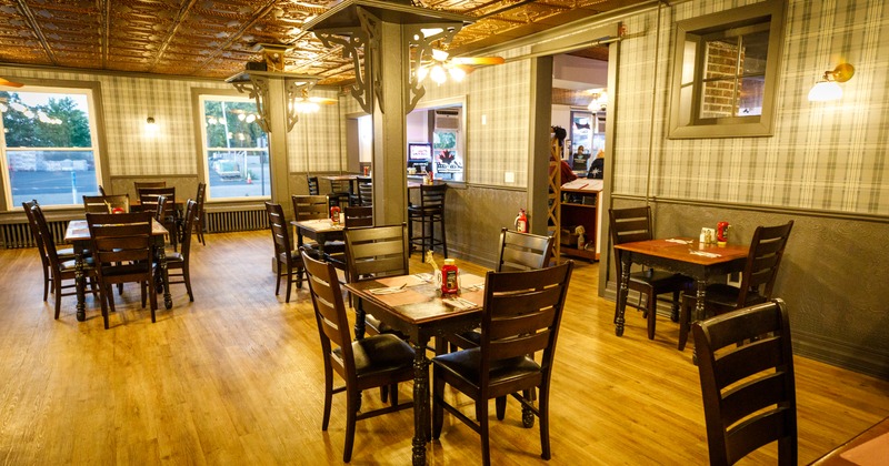 Interior - dining area with black wooden tables and chairs.