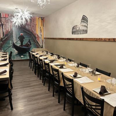 Interior dining area set up for group event featuring long communal tables.