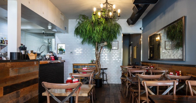 Interior, dining area, wooden top tables for two and four, serving station on the left