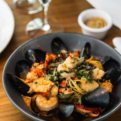 Seafood capellini mussels, shrimp, scallops, calamari and fresh herbs.