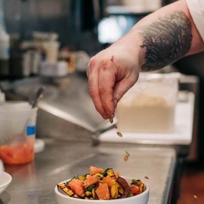 Chef garnishing a dish.