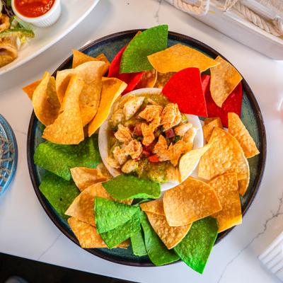 Shrimp guacamole served with colorful tortilla chips.