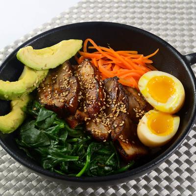 Pork Belly Rice Bowl with avocado, carrots, spinach and egg.