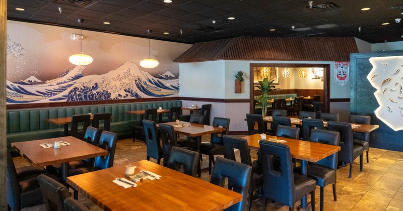 Modern dining room with wave mural and wooden tables