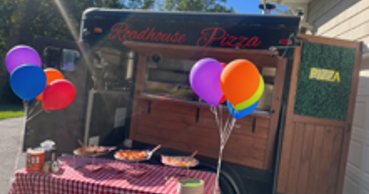 Outdoor seating area with tables, chairs, and patio umbrellas