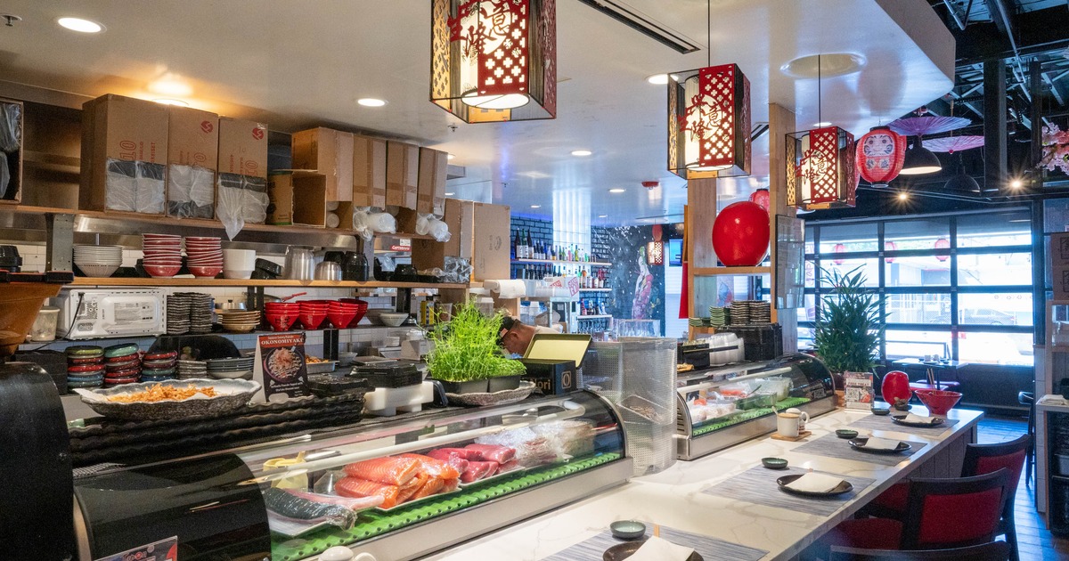 Restaurant interior, sushi bar, decorative red lanterns, neatly arranged seating