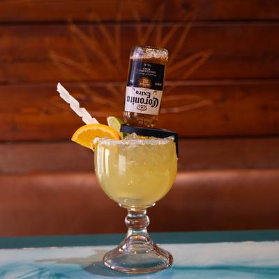 Margarita cocktail served with a bottle of beer inserted into a glass