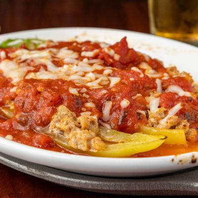 Stuffed Peppers topped with melted cheese and red sauce.