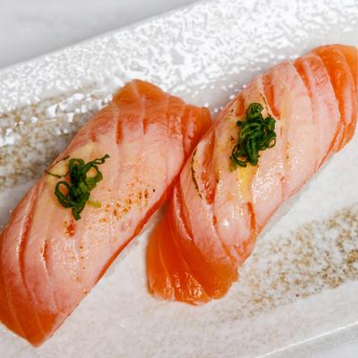 Aburi Salmon Nigiri featuring seared salmon over rice.