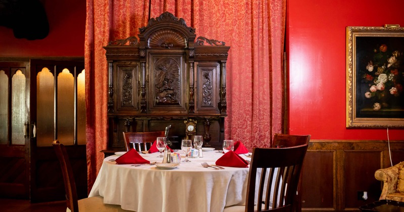 Interior, dining table with chairs, tableware, painting on the wall