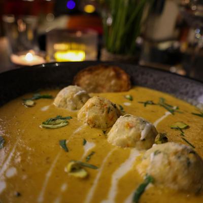 Malai Kofta featuring dumplings simmered in a rich, creamy, and mildly spiced gravy.