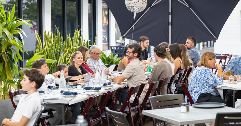 Outdoor seating area full of guests, birthday celebration