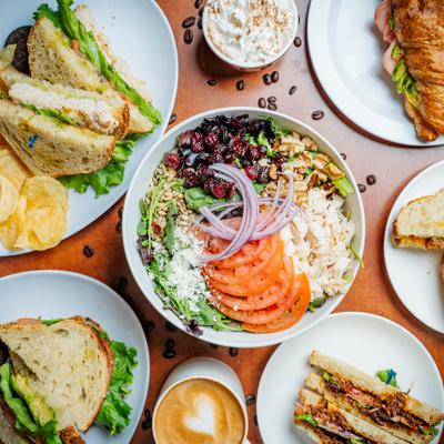 Craisin Chicken Salad served alongside other dishes and coffee drinks.