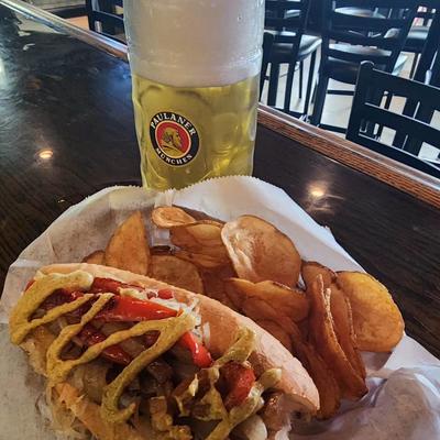 Bockwurst sandwich served  with a stein of beer.