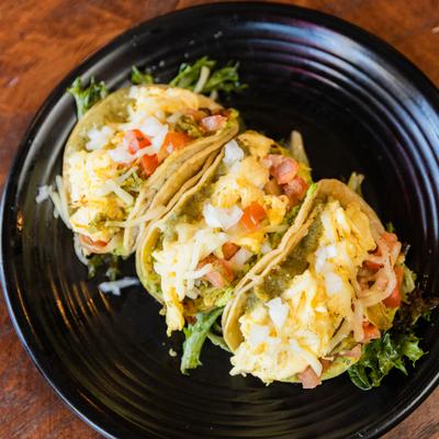 Tacos huevos featuring fluffy scrambled eggs, poblano peppers, and avocado.
