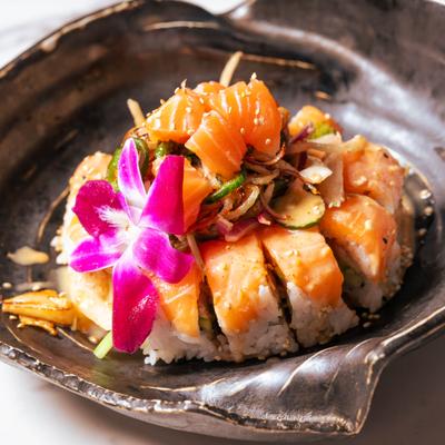 Fiesta Roll topped with salmon, crispy onion, cilantro and jalapeno.