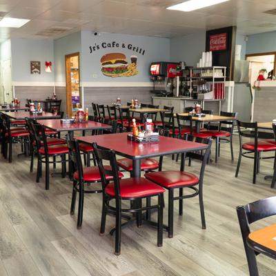 Casual restaurant interior with red tables, chairs, and soda fountain stations.