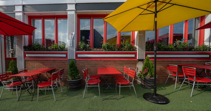 Outdoor seating area with red tables and chairs