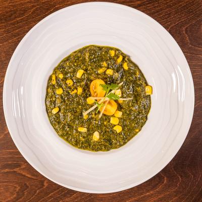 Corn cooked in a creamy spinach sauce.