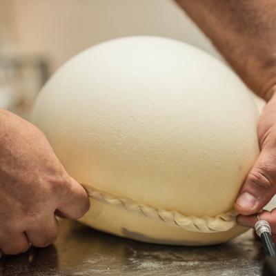 Giant Balloon Chebureki being prepared on the counter.