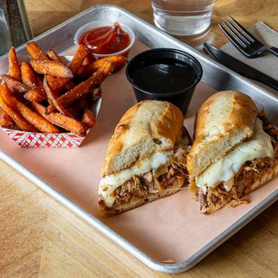 Pulled pork dip sandwich served with au jus, sweet potato fries and ketchup.
